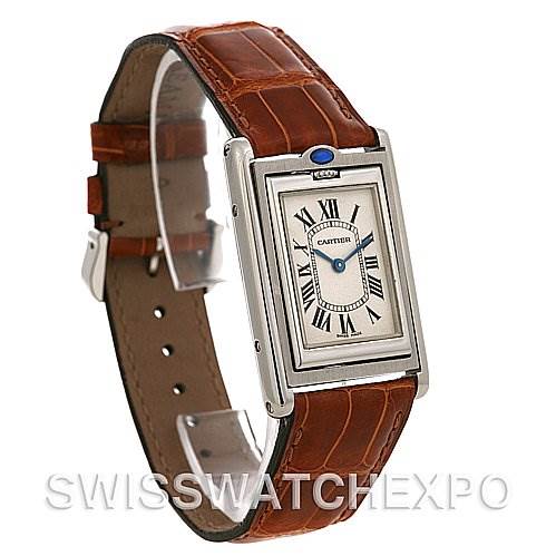 The image shows a Tank Basculante watch by Cartier at a slight angle, highlighting the rectangular face and brown leather strap.