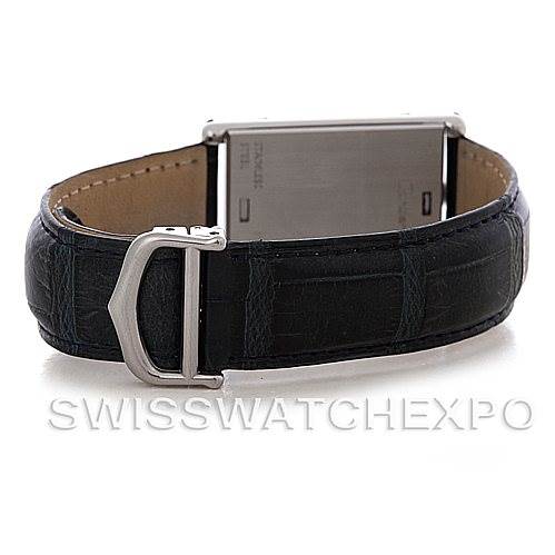 The image shows the back of a Cartier Tank Basculante Men's Stainless Steel Silver Dial Men's Stainless Steel Silver Dial watch, highlighting its leather strap and clasp.