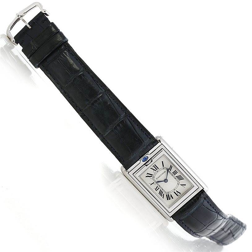 The image shows a Cartier Tank Basculante Men's Stainless Steel Silver Dial Men's Stainless Steel Silver Dial watch viewed from above, displaying its face, strap, and buckle.