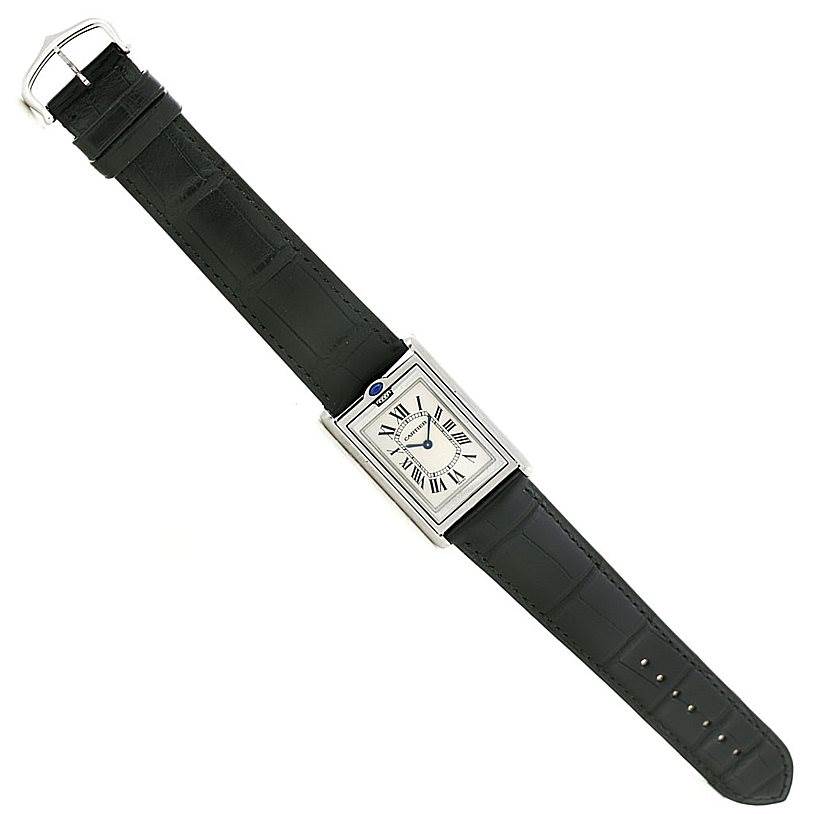 The Cartier Tank Basculante W1011358 Men's Stainless Steel Silver Dial W1011358 Men's Stainless Steel Silver Dial watch is shown in a top-down view, displaying the entire band and face.