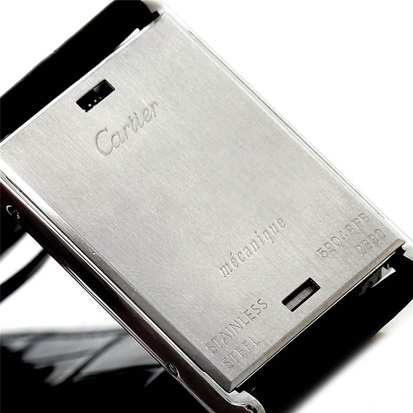 The image shows the case back of a Tank Basculante model by Cartier, highlighting its stainless steel material and inscriptions.
