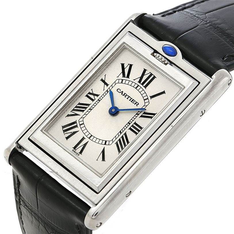 The image shows a close-up, top-down view of the Cartier Tank Basculante W1011358 Men's Stainless Steel Silver Dial W1011358 Men's Stainless Steel Silver Dial watch, featuring its dial, case, and leather strap.
