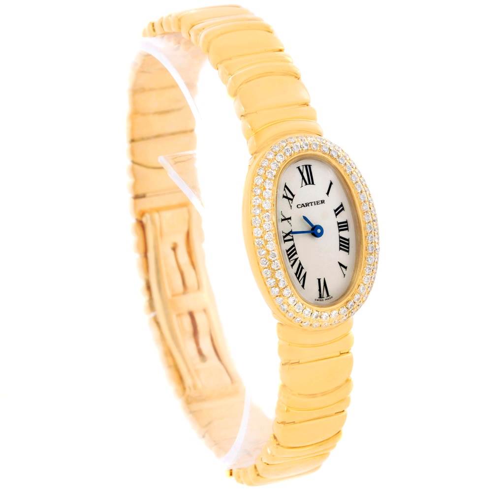 The image shows a Cartier Baignoire WB5094D8 Women's Yellow Gold Silver Dial WB5094D8 Women's Yellow Gold Silver Dial watch, displaying its oval face, diamond bezel, and gold bracelet at a slight angle.