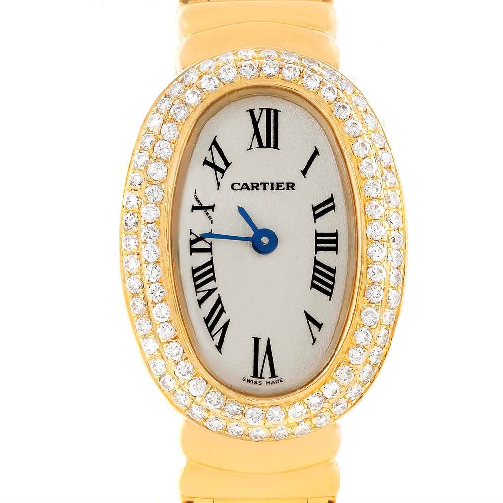 The image shows a close-up of the dial and bezel of a Cartier Baignoire WB5094D8 Women's Yellow Gold Silver Dial WB5094D8 Women's Yellow Gold Silver Dial watch, featuring a diamond-studded gold case and Roman numerals.