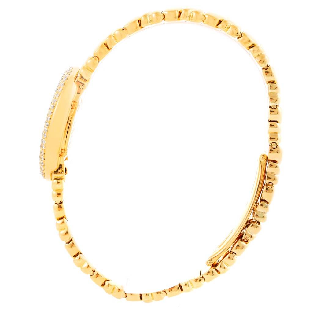 The image shows the side profile and bracelet of a Cartier Baignoire WB5094D8 Women's Yellow Gold Silver Dial WB5094D8 Women's Yellow Gold Silver Dial watch in gold with diamond accents around the case.