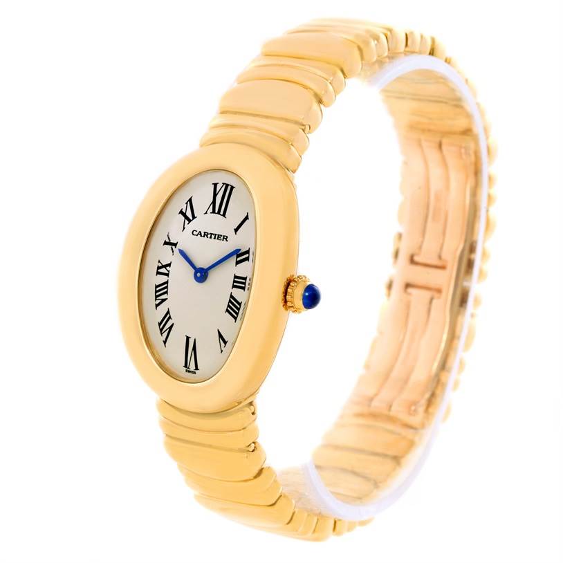 The image shows a Cartier Baignoire Women's Yellow Gold Silver Dial Women's Yellow Gold Silver Dial watch at a slight angle, highlighting its oval face, Roman numerals, and gold strap.
