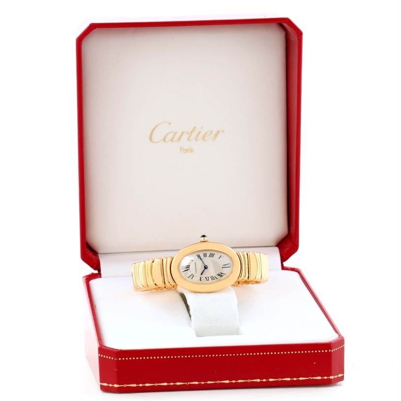 The Cartier Baignoire Women's Yellow Gold Silver Dial Women's Yellow Gold Silver Dial watch is shown in its red and white presentation box, highlighting the face and bracelet.