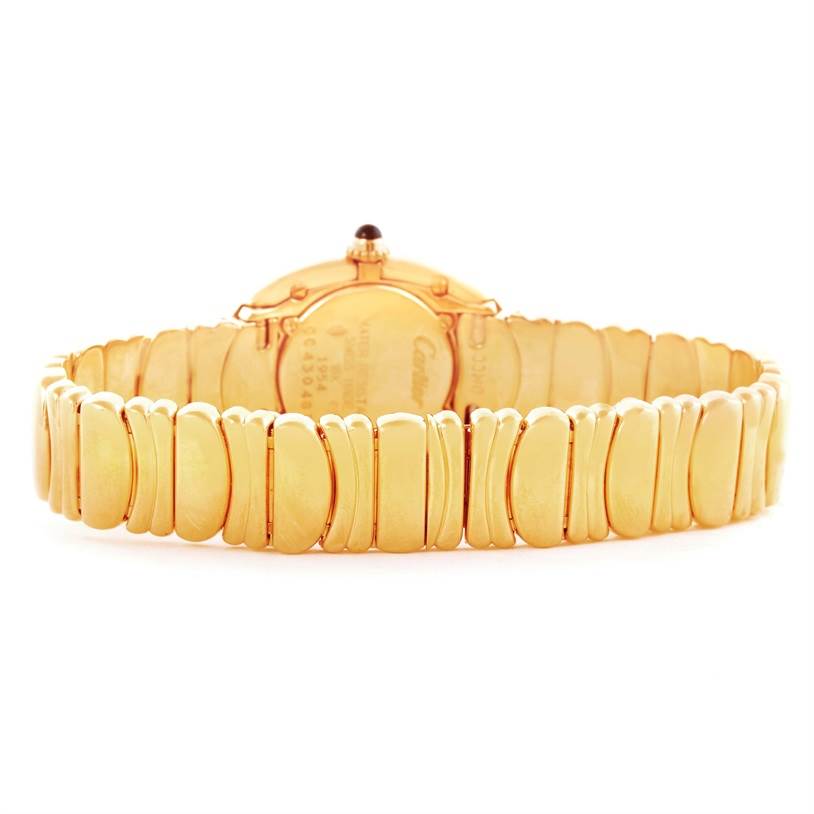 The image shows the back view of a Cartier Baignoire Women's Yellow Gold Silver Dial Women's Yellow Gold Silver Dial watch, highlighting its golden bracelet and back case.