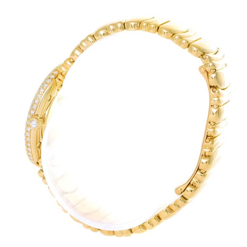 The image shows a side angle of the gold and diamond-embellished bracelet of the Cartier Baignoire 1950 Women
s Yellow Gold Silver Dial 1950 Women
s Yellow Gold Silver Dial watch.