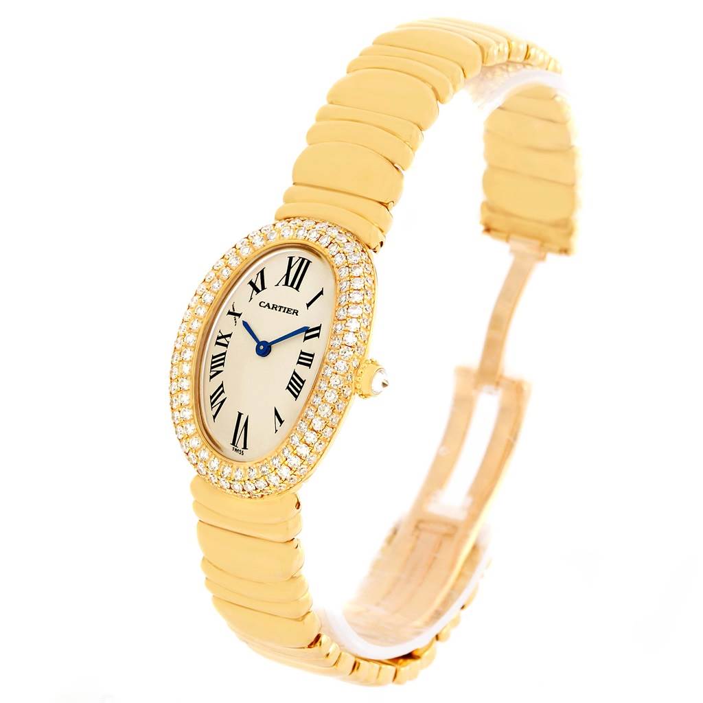 This image shows a Cartier Baignoire 1950 Women's Yellow Gold Silver Dial 1950 Women's Yellow Gold Silver Dial watch from a three-quarter angle, highlighting its oval face and gold band.