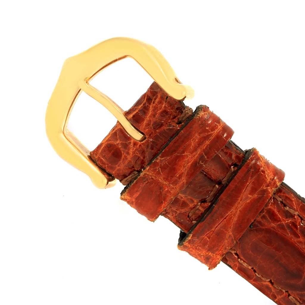 This image shows the brown leather strap and gold buckle of a Cartier Baignoire 1954 Women
s Yellow Gold Silver Dial 1954 Women
s Yellow Gold Silver Dial watch.