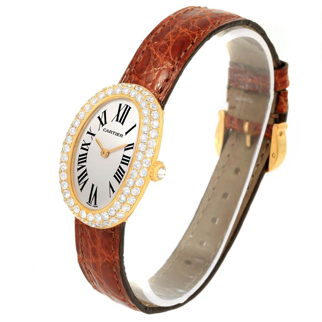 The image shows a Cartier Baignoire 1954 Women
s Yellow Gold Silver Dial 1954 Women
s Yellow Gold Silver Dial watch at a slight angle, highlighting the face, bezel with diamonds, and brown leather strap.