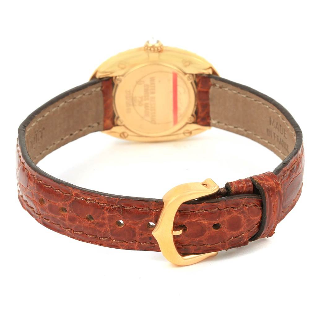 The image shows the back of the Cartier Baignoire 1954 Women
s Yellow Gold Silver Dial 1954 Women
s Yellow Gold Silver Dial watch, highlighting its leather strap and buckle.