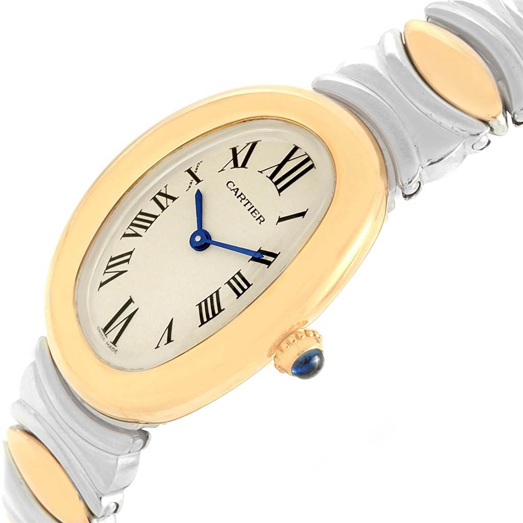 The image shows a close-up of a Cartier Baignoire W15045D8 Women's Yellow Gold Silver Dial W15045D8 Women's Yellow Gold Silver Dial watch, highlighting the oval face, Roman numerals, and the bracelet.