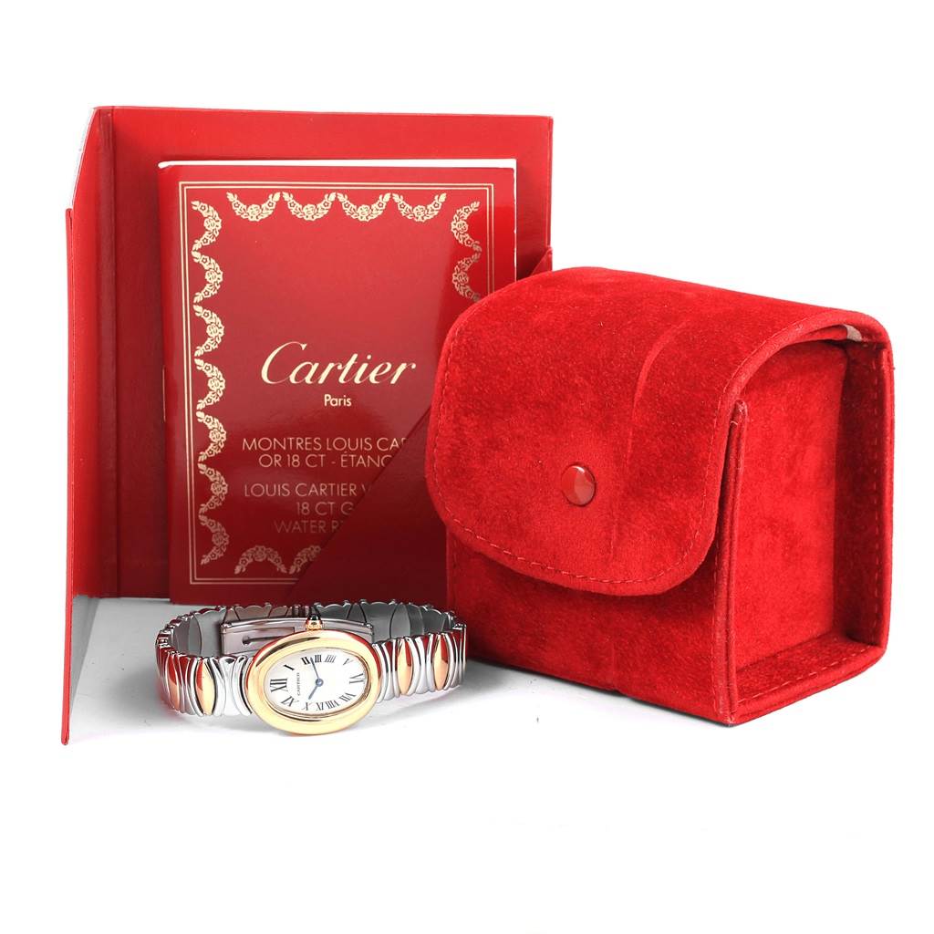 The angle shows the Cartier Baignoire W15045D8 Women's Yellow Gold Silver Dial W15045D8 Women's Yellow Gold Silver Dial watch facing forward, alongside its red case and warranty booklet.