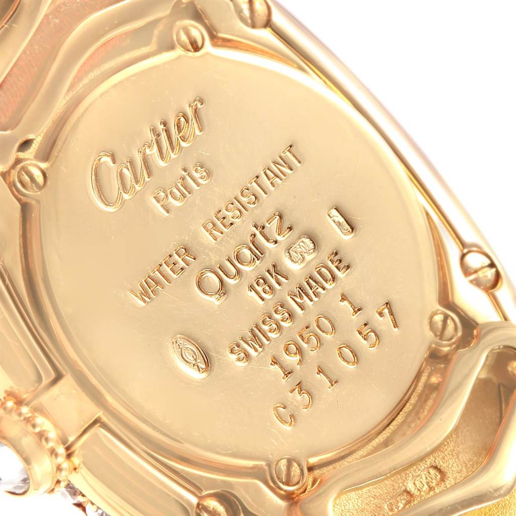 This image shows the back case of a Cartier Baignoire 1950 Women's Yellow Gold Silver Dial 1950 Women's Yellow Gold Silver Dial watch, highlighting the engraved details such as material and serial numbers.