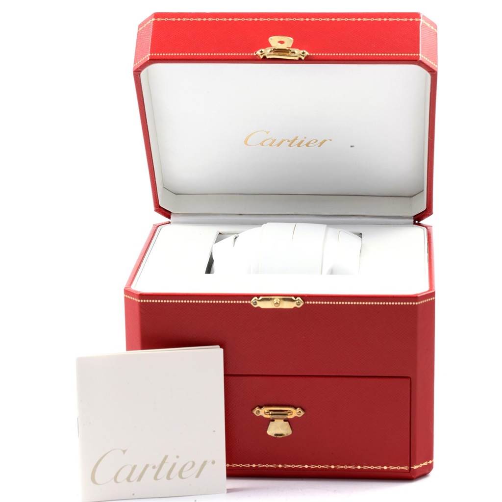 The image shows a Cartier Baignoire 1950 Women's Yellow Gold Silver Dial 1950 Women's Yellow Gold Silver Dial watch in its open red box, with a Cartier booklet beside it.