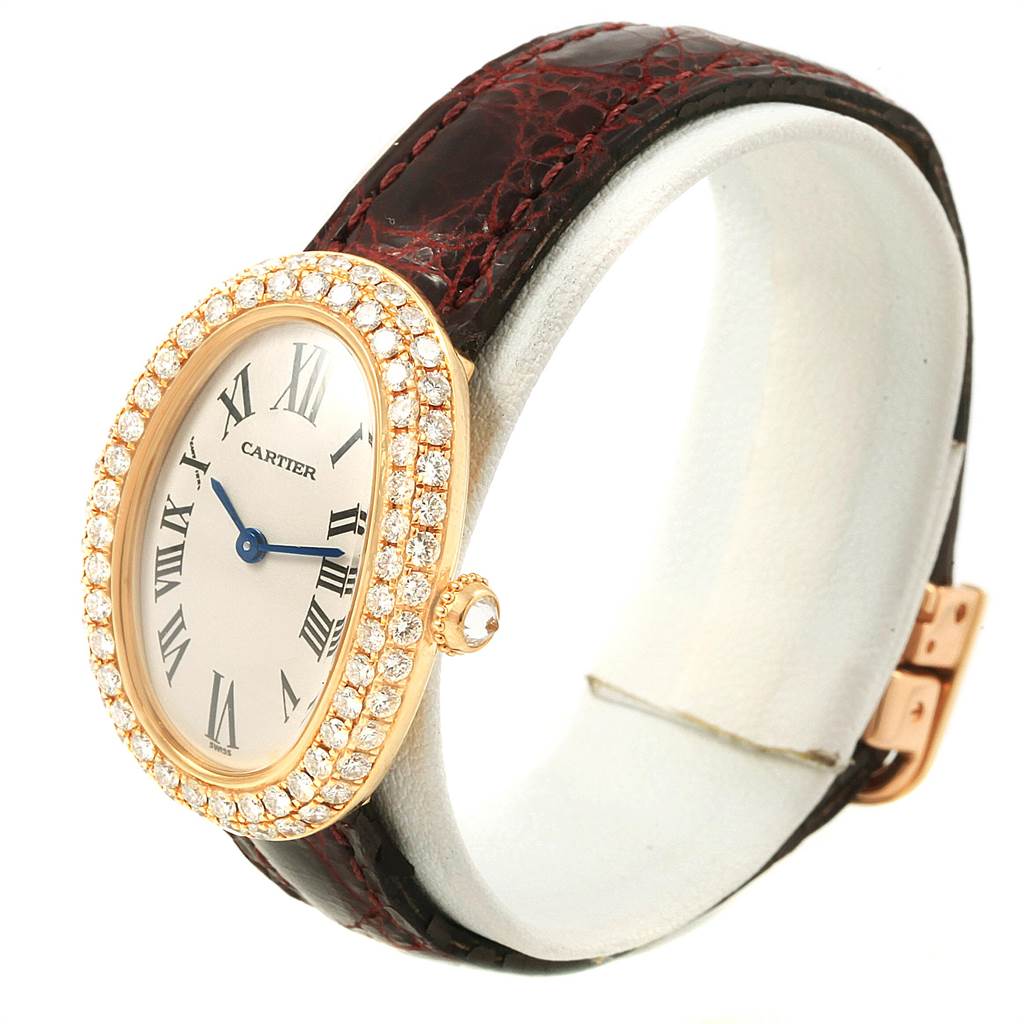 This Cartier Baignoire 1954 Women's Yellow Gold Silver Dial 1954 Women's Yellow Gold Silver Dial watch is shown from an angled view, displaying the face, diamond bezel, and part of the leather strap.