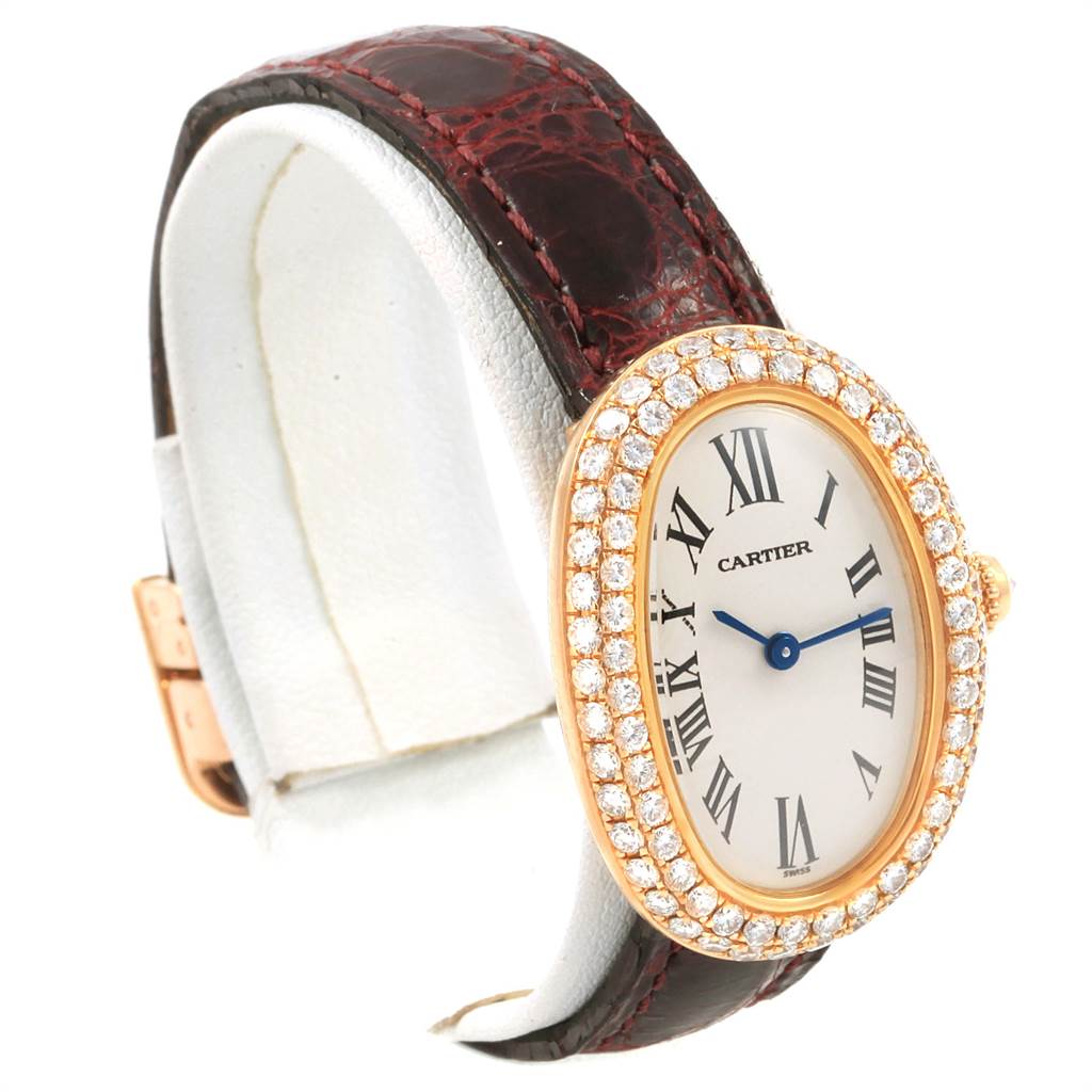 The image shows a Cartier Baignoire 1954 Women's Yellow Gold Silver Dial 1954 Women's Yellow Gold Silver Dial watch with a diamond-encrusted bezel, Roman numeral dial, and brown leather strap, captured at an angled side view.