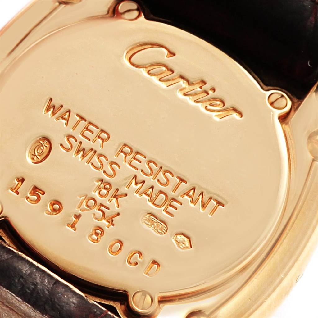 This image shows the back case of a Cartier Baignoire 1954 Women's Yellow Gold Silver Dial 1954 Women's Yellow Gold Silver Dial watch with inscriptions detailing its specifications.