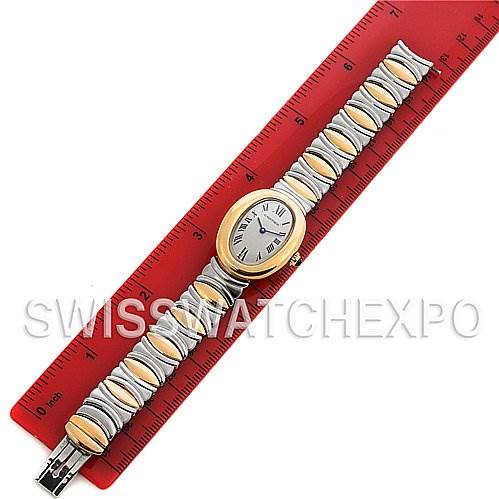 The Cartier Baignoire W15045D8 Women's Yellow Gold Silver Dial W15045D8 Women's Yellow Gold Silver Dial watch is shown from a top-down angle, displaying the full bracelet, oval dial, and red ruler for scale.