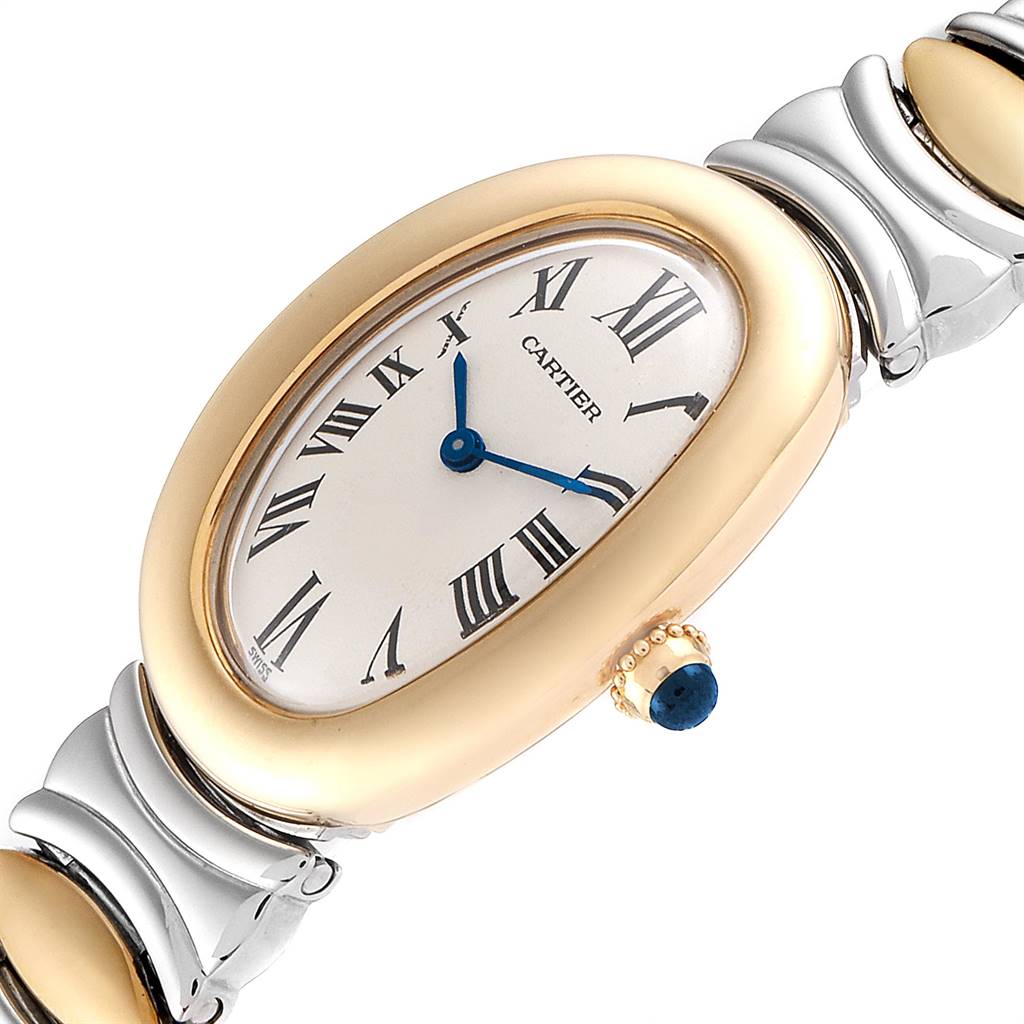 The Cartier Baignoire W15045D8 Women's Yellow Gold Silver Dial W15045D8 Women's Yellow Gold Silver Dial watch is shown at an angle highlighting the oval dial, gold and steel bracelet, and a sapphire cabochon crown.