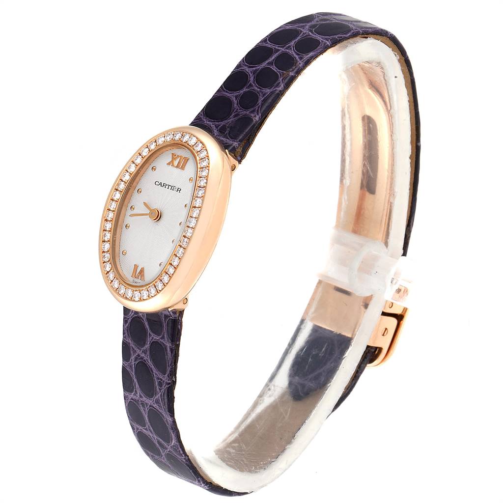 The Cartier Baignoire 2333 Women's Rose Gold Silver Dial 2333 Women's Rose Gold Silver Dial watch is displayed at an angle showing its oval face, gemstone bezel, Roman numerals, and black leather strap.