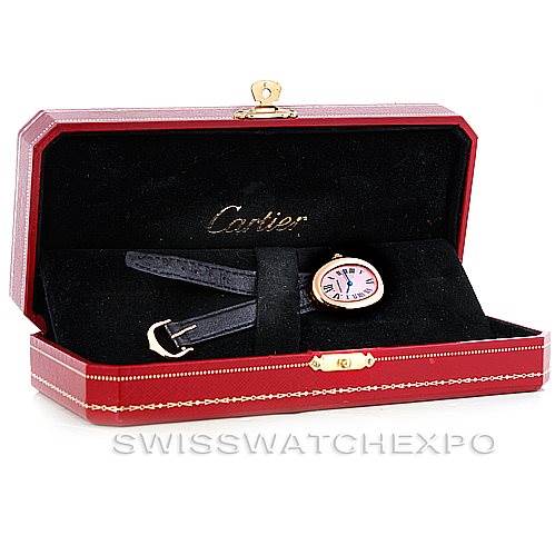 The Baignoire model by Cartier is shown in its open red case, displaying the face and strap of the watch.