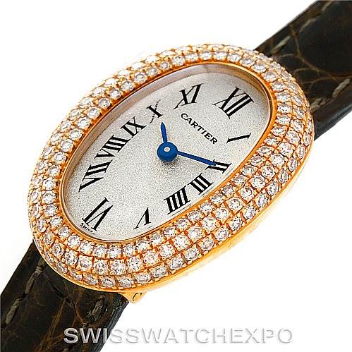 The Cartier Baignoire WB501651 Women's Yellow Gold Silver Dial WB501651 Women's Yellow Gold Silver Dial watch is shown from a top angle, featuring its oval-shaped face with diamond accents and black leather strap.