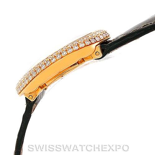 Side view of a Cartier Baignoire WB501651 Women's Yellow Gold Silver Dial WB501651 Women's Yellow Gold Silver Dial watch showcasing its diamond-encrusted bezel and black strap.