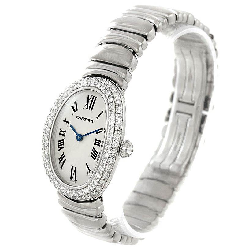 The Cartier Baignoire WB5097L2 Women's White Gold Silver Dial WB5097L2 Women's White Gold Silver Dial watch is shown at an angle displaying its face, diamond-studded bezel, and metallic strap.