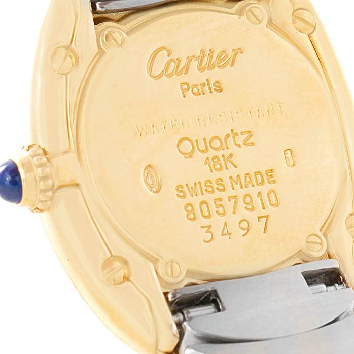 This image shows the back of a Cartier Baignoire W15045D8 Women's Yellow Gold Silver Dial W15045D8 Women's Yellow Gold Silver Dial watch, detailing its case, hallmark, and the crown with a blue cabochon.