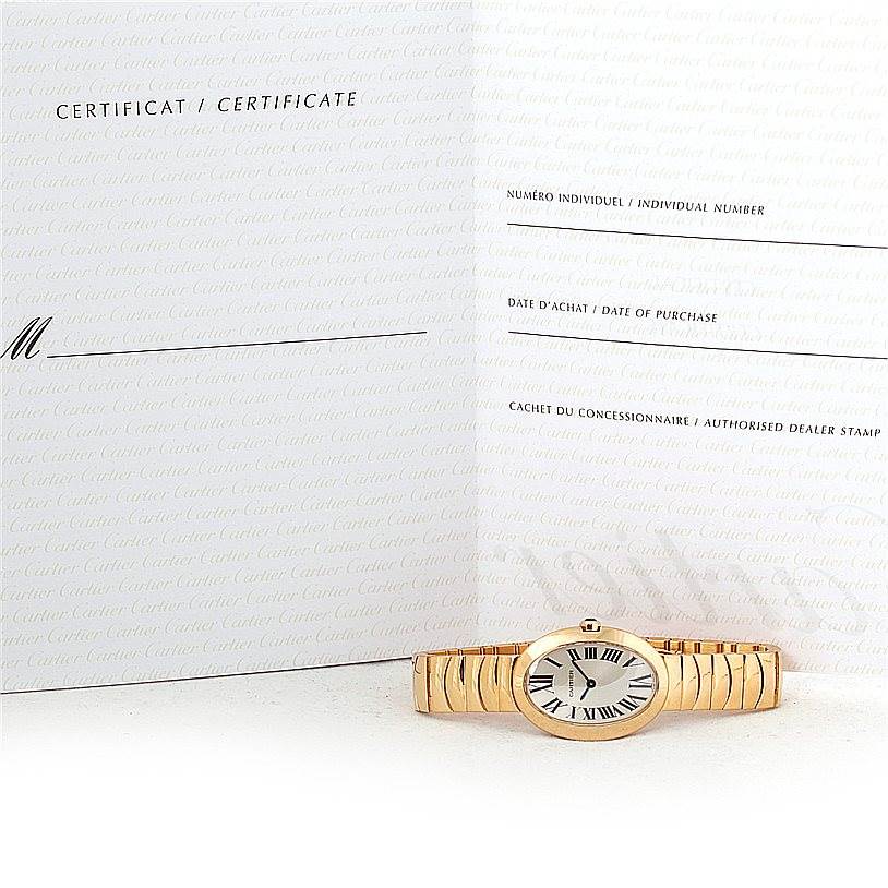 The image shows a Cartier Baignoire W8000008 Women's Yellow Gold Silver Dial W8000008 Women's Yellow Gold Silver Dial watch laid flat from the front, alongside its certificate.