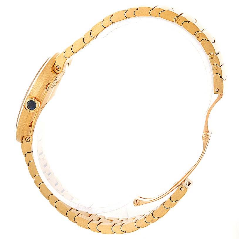 The image shows a side view of the Cartier Baignoire W8000008 Women's Yellow Gold Silver Dial W8000008 Women's Yellow Gold Silver Dial watch, focusing on its gold bracelet and crown.