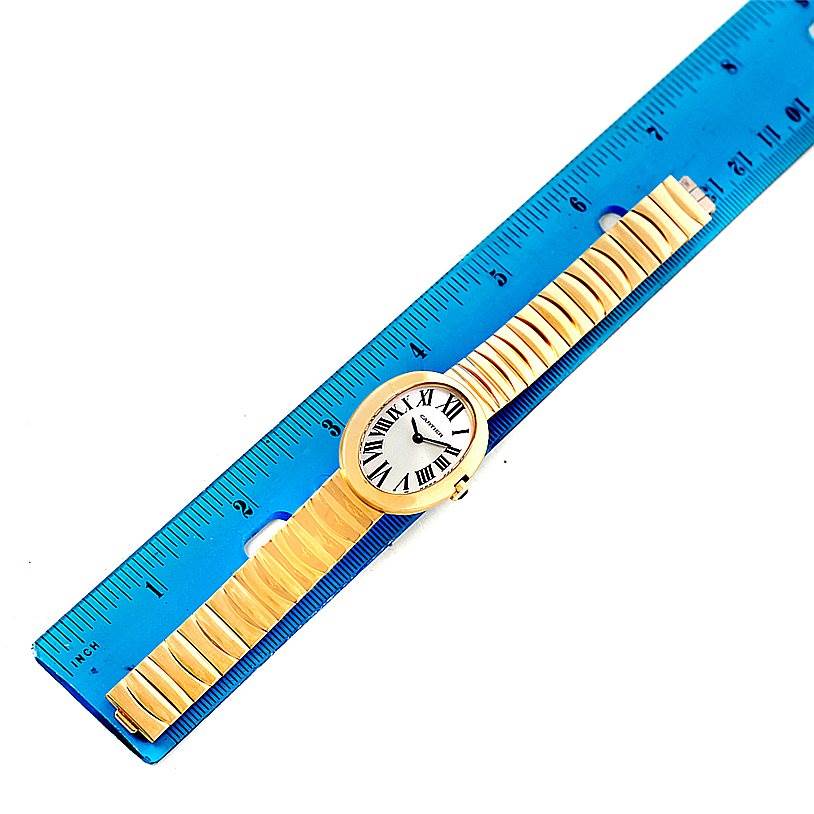 The Cartier Baignoire W8000008 Women's Yellow Gold Silver Dial W8000008 Women's Yellow Gold Silver Dial watch is shown from a top-down angle next to a ruler for scale.