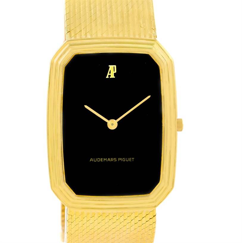 This image shows a front view of a Vintage Audemars Piguet watch, displaying its black dial, gold rectangular case, and gold mesh band.
