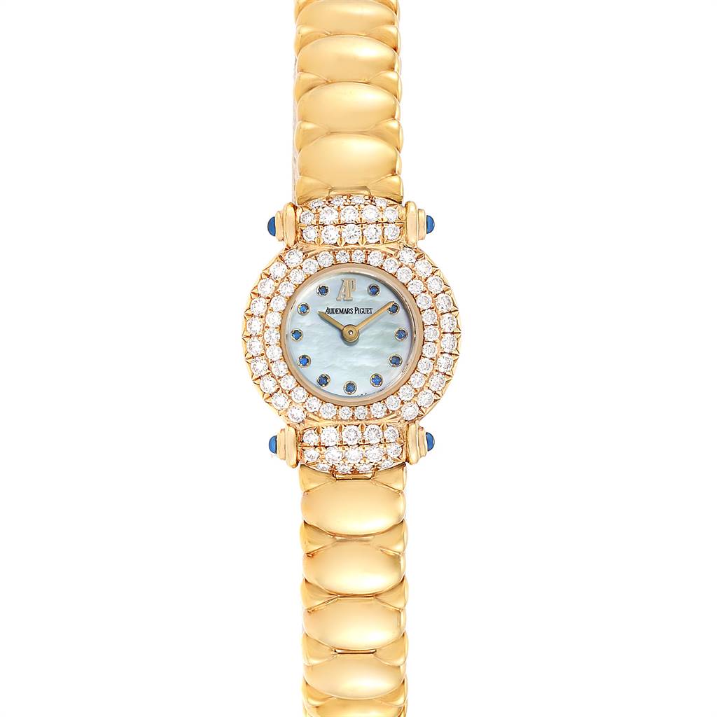 The image shows a front view of a Vintage Audemars Piguet watch with a gold bracelet and diamond-studded bezel.