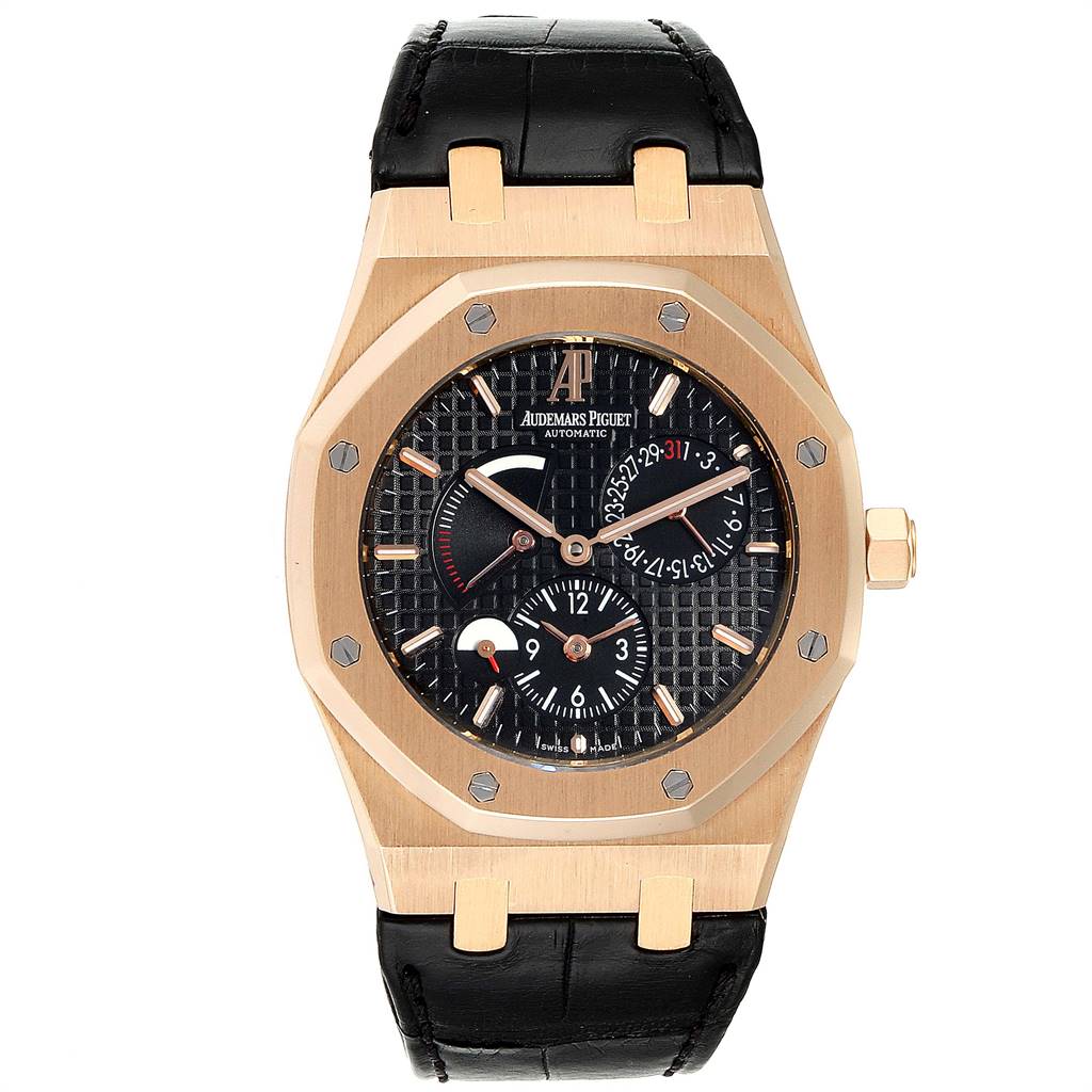 The Royal Oak by Audemars Piguet is shown from a front angle, displaying its octagonal bezel, patterned black dial, and leather strap.