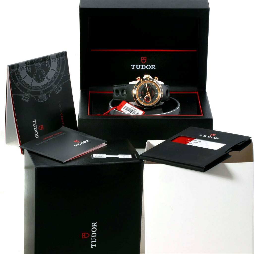 The Grantour model by Tudor is shown inside its box along with booklets and card holders, viewed from a slightly elevated angle.