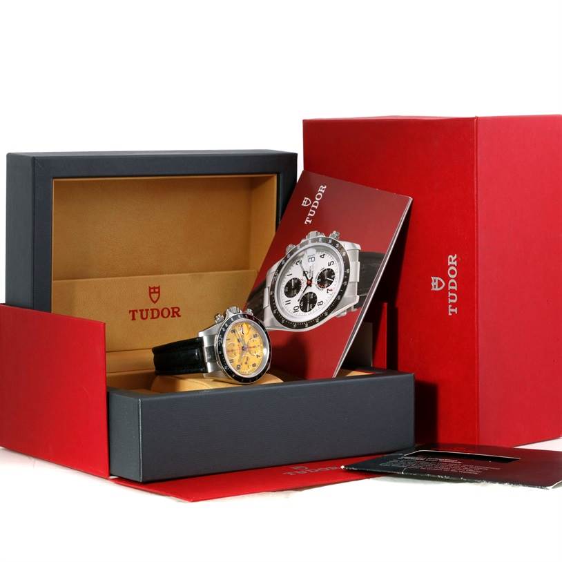 The image shows a Tudor Prince model watch and its accessories, including the box and manual, from a front angle.