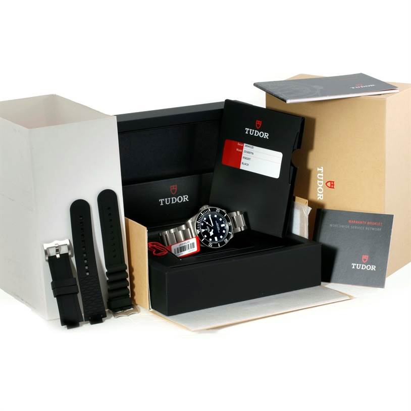 The image shows a Tudor Pelagos 25500TN Men's Titanium Black Dial 25500TN Men's Titanium Black Dial watch with its box, booklets, and additional straps.