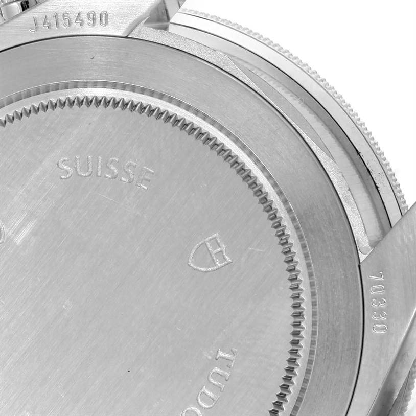 The image shows a close-up of the caseback and crown guard of a Tudor Heritage Chrono 70330N-95740 Men's Stainless Steel Grey Dial 70330N-95740 Men's Stainless Steel Grey Dial watch.