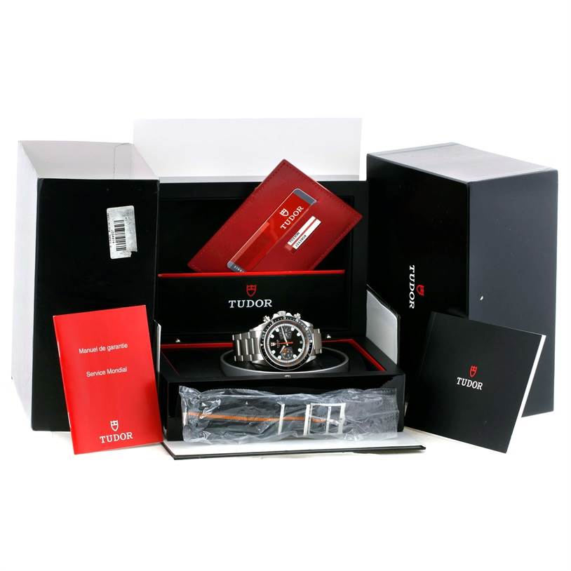 This image shows the Tudor Heritage Chrono 70330N-95740 Men's Stainless Steel Black Dial 70330N-95740 Men's Stainless Steel Black Dial watch from a front angle, inside its original packaging with manuals and accessories.
