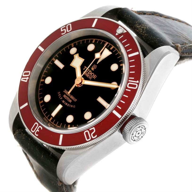 The image shows a Tudor Heritage Black Bay 79220R Men's Stainless Steel Black Dial 79220R Men's Stainless Steel Black Dial watch at an angled close-up, displaying the dial, bezel, and part of the leather strap.