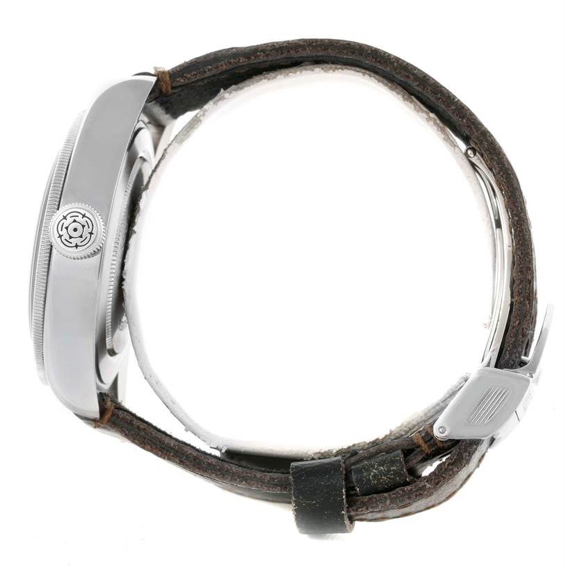 The image shows a side profile of the Tudor Heritage Black Bay 79220R Men's Stainless Steel Black Dial 79220R Men's Stainless Steel Black Dial watch, highlighting the crown and leather strap.