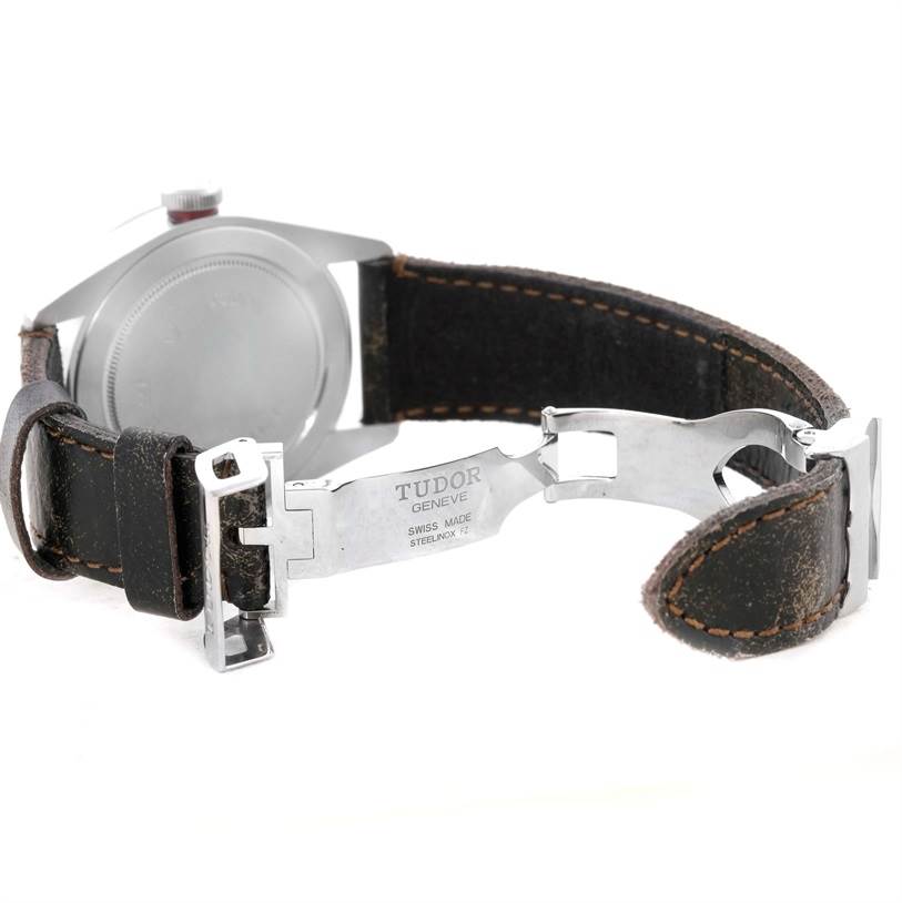 This image shows the open clasp and backside of the Tudor Heritage Black Bay 79220R Men's Stainless Steel Black Dial 79220R Men's Stainless Steel Black Dial watch with its leather strap.