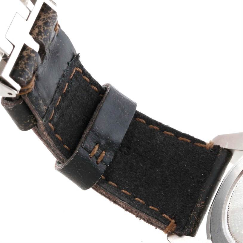 The image shows a close-up of the leather strap and part of the buckle of a Tudor Heritage Black Bay 79220R Men's Stainless Steel Black Dial 79220R Men's Stainless Steel Black Dial watch.