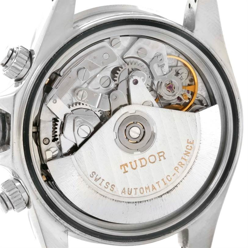 The image shows the intricate movement through the transparent case back of a Tudor Prince model watch from a close-up angle.