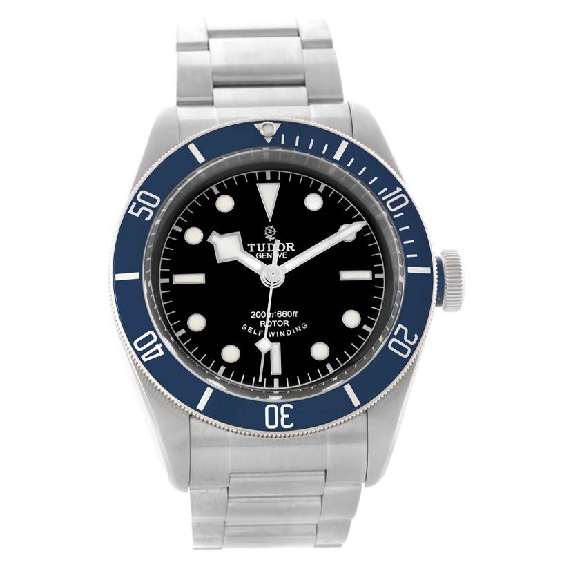 The Tudor Heritage Black Bay 79220 Men's Stainless Steel Black Dial 79220 Men's Stainless Steel Black Dial watch is shown from a front angle, displaying its dial, bezel, and bracelet.