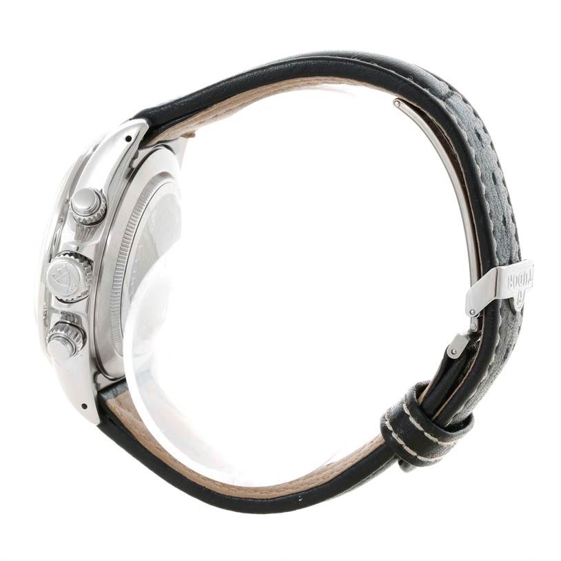 This side view of the Tudor Tiger 79273 Men's Stainless Steel White Dial 79273 Men's Stainless Steel White Dial watch shows the case, three crown buttons, and leather strap with a buckle.